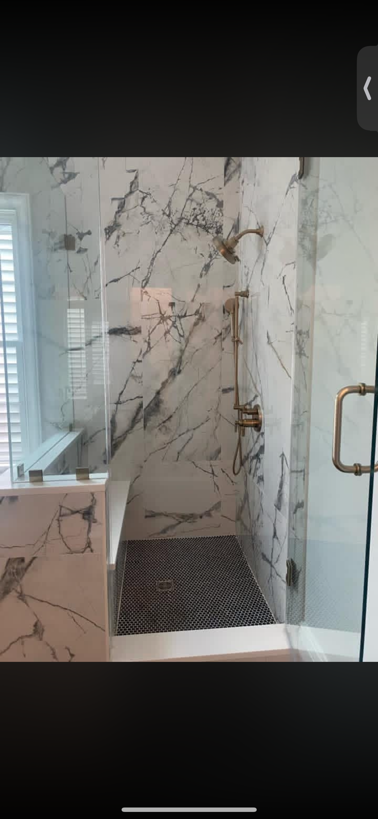 Marble tile shower with brass fixtures