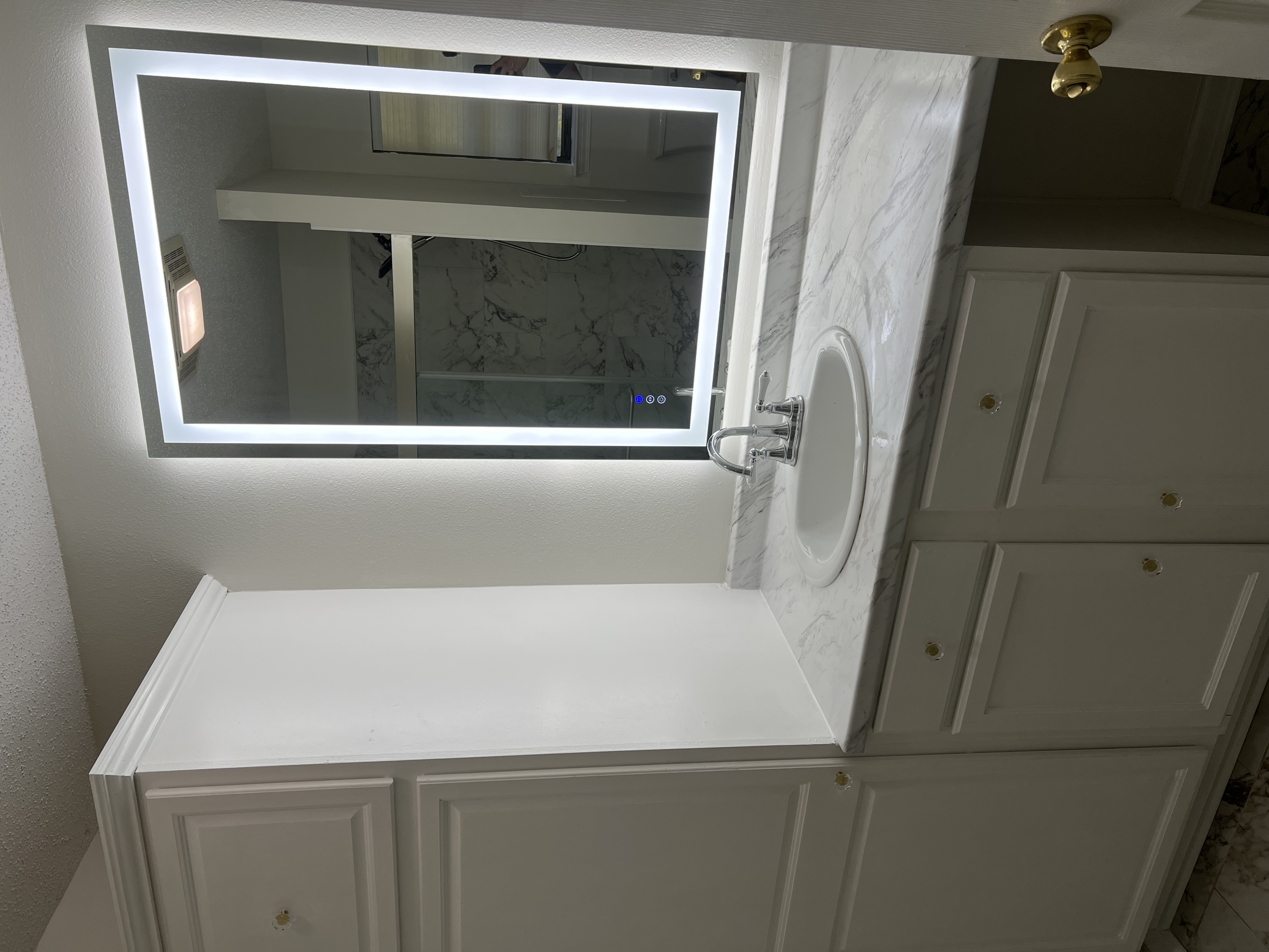 Bathroom vanity with backlit LED mirror